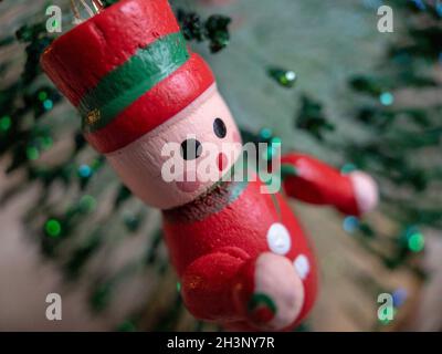 New Year's decor on the Christmas tree in the form of a handmade soft toy Santa Claus and glass balls. Postcard. Stock Photo