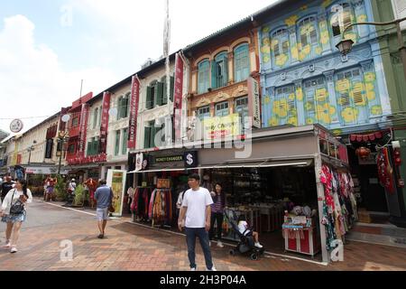 Shops and old shop houses with the Chinatown Heritage Centre and several people walking in Pagoda Street in the Chinatown District, Singapore. Stock Photo