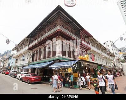 Juncture between Temple Street and Trengganu Street with old shop houses, shops and stalls and people walking in Singapore's Chinatown. Stock Photo