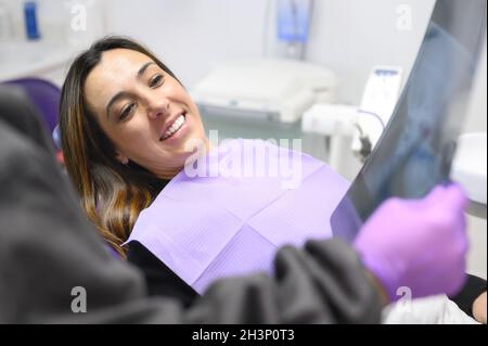 Doctor dentist showing patient's teeth on X-ray Stock Photo