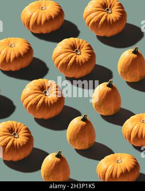 Pumpkins patterned over blue background Stock Photo
