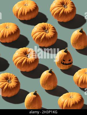 Pumpkins patterned over blue background with evil laughing pumpkin Stock Photo