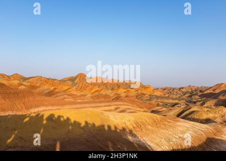 Rainbow mountain in sunset with shadow of tourists Stock Photo