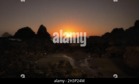 The Moon Setting Over a Rocky Beach at Night Stock Photo
