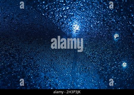 Closeup Rain Drops On Blue background Glass Stock Photo