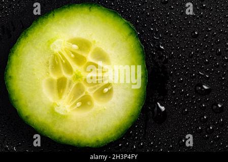 Cucumber slice isolated on black background closup details Stock Photo