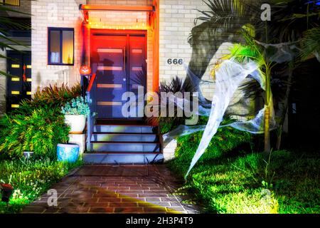 Decoration of residential house in Sydney city suburb for Halloween fun holiday with usual creepy characters at night with lights. Stock Photo