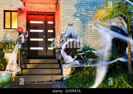 Halloween celebration and decoration of a residential house in Sydney suburb with lights and spider webs. Stock Photo