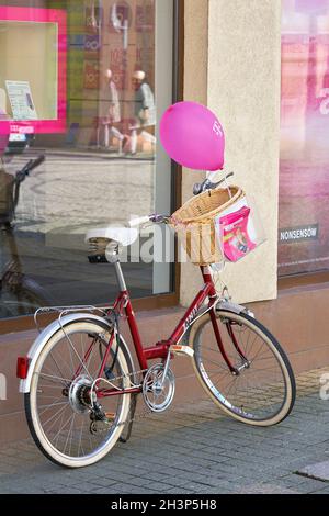 Telekom advertising campaign in front of a branch in the old town of Swinoujscie in Poland Stock Photo