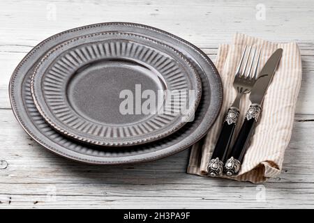 Plate, knife and fork on a wooden table Stock Photo