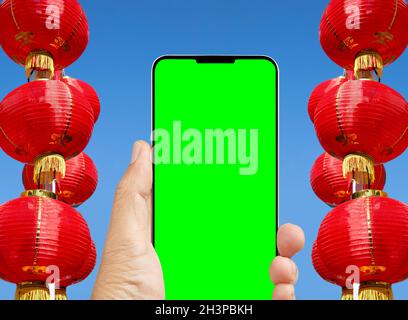 The Yuan digital on cell phone in chinese lunar new year,  shopping online ,chroma key screen. Stock Photo