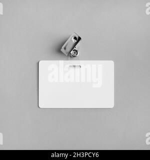 Photo of blank white plastic badge on vintage wooden table background ...