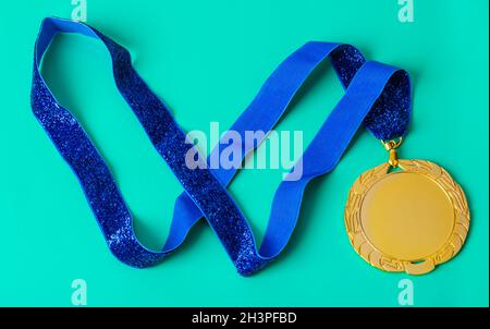 Gold medal on green Stock Photo