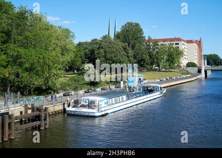 Excursion boat at the pier on the bank of the Spree in Berlin Stock Photo