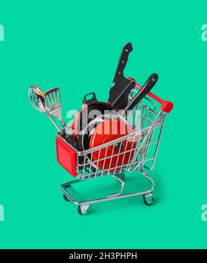 Toy kitchenware in shopping cart Stock Photo