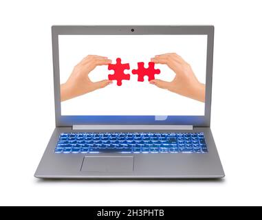 Hands and puzzle in computer notebook Stock Photo