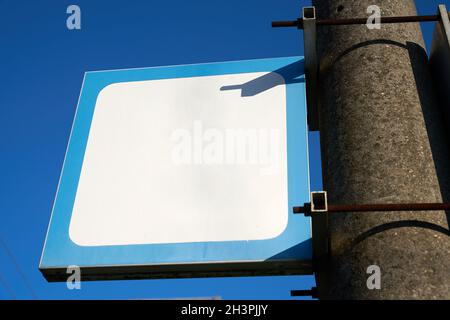 Blank white sign with text space copy space without inscription on a pillar at the station Stock Photo