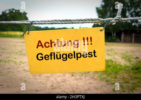Sign at the entrance of a farm in Germany with the inscription Attention avian influenza Stock Photo