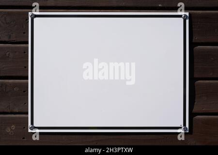 Blank white sign with place for text on wooden wall Stock Photo
