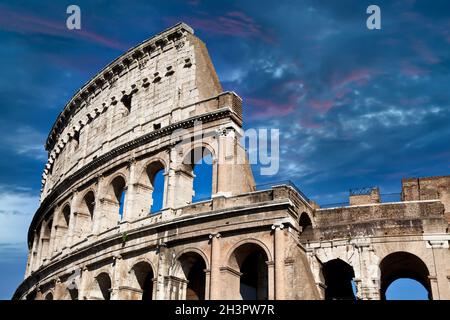 Rome, Italy. Arches archictecture of Colosseum exterior with blue sky background and clouds. Stock Photo