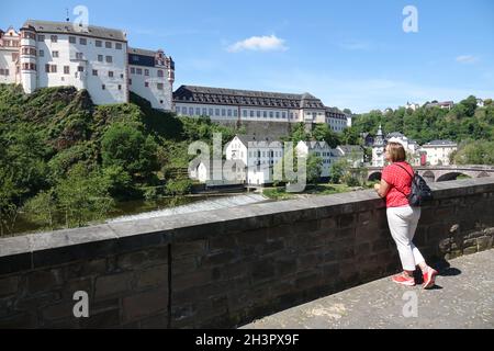 View from the Lahn bridge to the castle in Weilburg Stock Photo