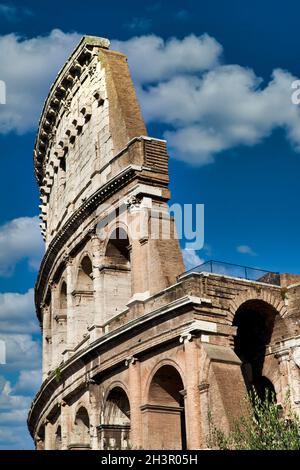 Rome, Italy. Arches archictecture of Colosseum exterior with blue sky background and clouds. Stock Photo