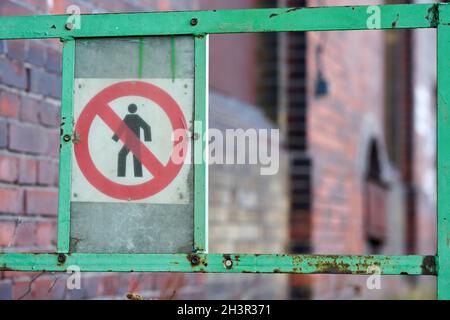 Old no trespassing sign from the GDR on a fence in the port of Magdeburg in Germany Stock Photo