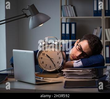 Businessman falling asleep during long hours in office Stock Photo