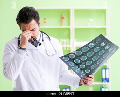 Doctor radiologist looking at x-ray scan in hospital Stock Photo