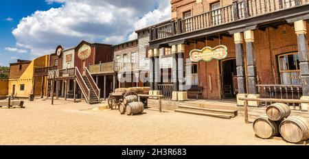 Vintage Far West town with saloon. Old wooden architecture in Wild West. Stock Photo