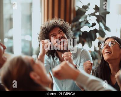 Happy diverse business people celebrating successful teamwork result, business achievement. Stock Photo