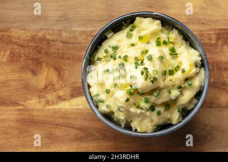 Pomme puree, a bowl of mashed potatoes with scallions and thyme