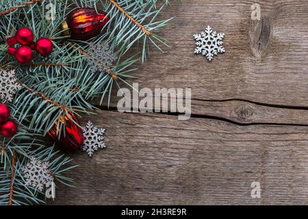 Fir branch with with Christmas decorations on old wooden background with copy space for text. Selective focus. Stock Photo