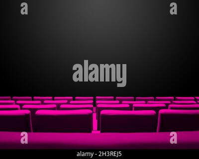 Cinema movie theatre with pink seats rows and a black background Stock Photo