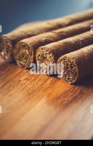 Group of brown cuban cigars on wooden background Stock Photo