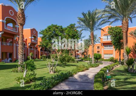 Hurghada, Egypt - September 25 2021: A stone sidewalk through a beautiful Egyptian garden in Hurghada Stock Photo