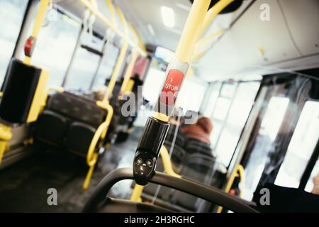 Red stop button in a bus, commuting, public transport Stock Photo