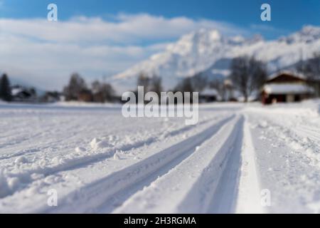 Cross-country skiing in Austria: Slope, fresh white powder snow and mountains, blurry background Stock Photo