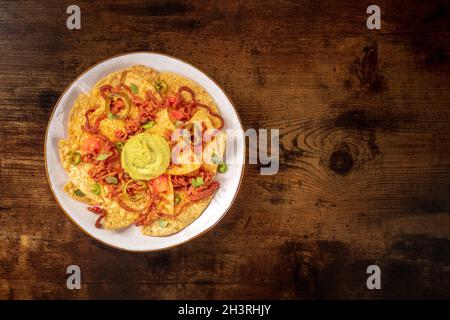Nachos, Mexican tortilla chips, with beef and guacamole, shot from above Stock Photo