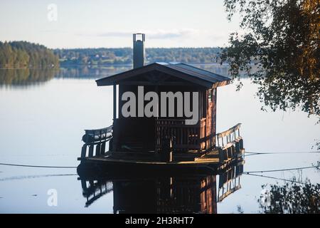 Finnish wooden floating sauna boat on the river in Lapland, Finland, summer day Stock Photo