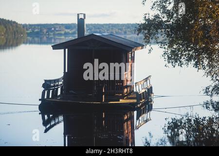 Finnish wooden floating sauna boat on the river in Lapland, Finland, summer day Stock Photo