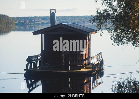 Finnish wooden floating sauna boat on the river in Lapland, Finland, summer day Stock Photo