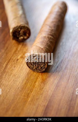 Group of brown cuban cigars on wooden background Stock Photo