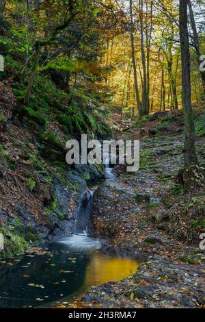 Autumn sunrise in the valley of Ninglinspo, which is classed as an outstanding heritage area of Wallonia. The stream forms rapids around various pools Stock Photo