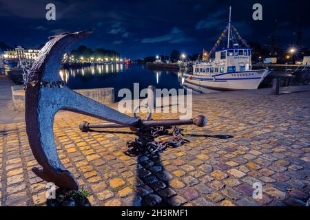 Honfleur, France - July 28, 2021: Blue hour scene with anchor at historical port of Honfleur, a french commune in the Calvados, Normandy Stock Photo