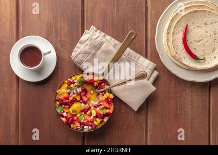 Huevos rancheros, Mexican baked eggs, shot from the top with pico de gallo Stock Photo