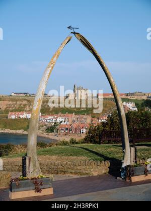 The Whalebone Arch in Whitby in North Yorkshire framing the distant gothic Church of St Mary in the background England UK Stock Photo
