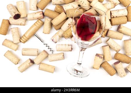 Glass of red wine with corks and corkscrew on a qhite background with copy space Stock Photo