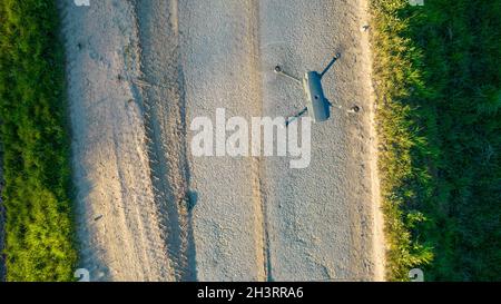 Aerial drone shot of a Drone quadcopter with digital camera, Modern technology, UAV concept. Drone flying over fields and a road Stock Photo