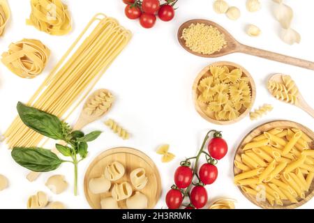 Overhead photo of different types of pasta on white, forming frame Stock Photo